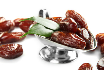 Dried dates in metal dish isolated on white
