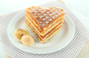 Sweet Belgium waffles with banana, isolated on white