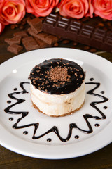 Sweet cake with chocolate on plate on table close-up