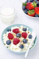 bowl of cottage cheese with berries, honey and nut for breakfast