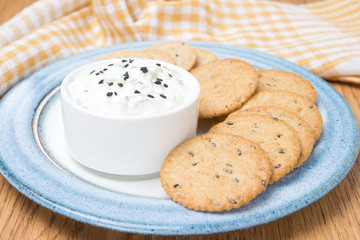snack - sauce with feta cheese and whole grain crackers