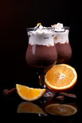 Tasty dessert with chocolate, cream and orange sauce,