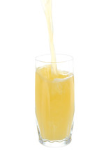 Juice pouring into glass isolated on white