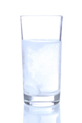 Glass with efervescent tablet in water with bubbles isolated