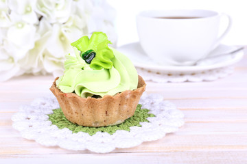 Tasty cake on table on light background
