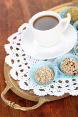 Set of chocolate candies, on tray, on wooden background