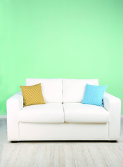 White sofa in room on green background