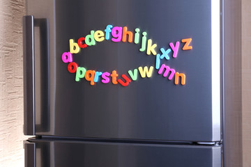 Colorful magnetic letters on  refrigerator © Africa Studio