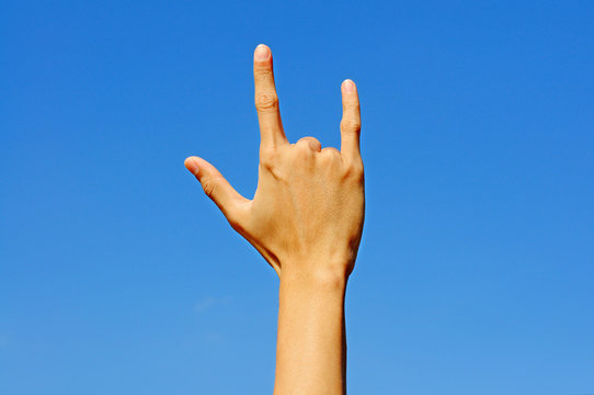 I love you in hand sign language on blue sky background.