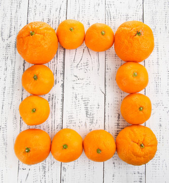 Ripe sweet tangerines on color wooden background