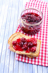 Delicious toast with jam on table close-up