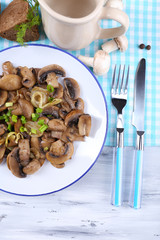 Delicious fried mushrooms on plate on table close-up