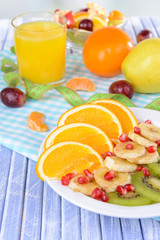 Sweet fresh fruits on plate on table close-up
