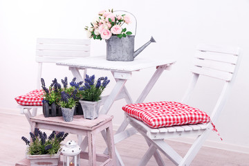 Garden chairs and table with flowers