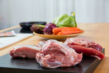 Meat parts with vegetables at background