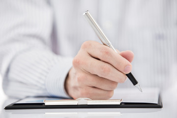 man hand with pen and business report