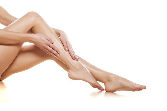 woman apply cream on her bare feet
