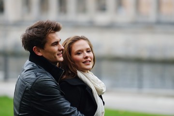 Naklejka premium Lovely couple enjoying fall in love at park