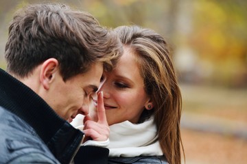 Lovely couple enjoying fall in love at park