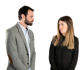 Young couple doing a joke over isolated white background