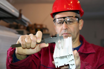 Worker Using a Vernier Caliper