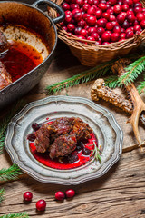 Fototapeta na wymiar Roast venison with cranberry sauce with rosemary