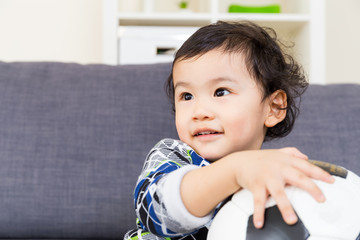 Asian baby boy holding soccer ball