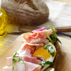 Bacon and fried eggs open sandwich