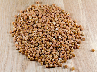 Buckwheat grains on wooden surface