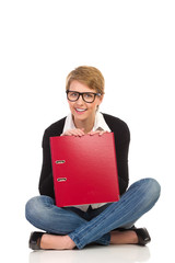 Attractive female student sitting with crossed legs.