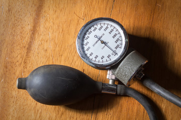 Sphygmomanometer on wood table.