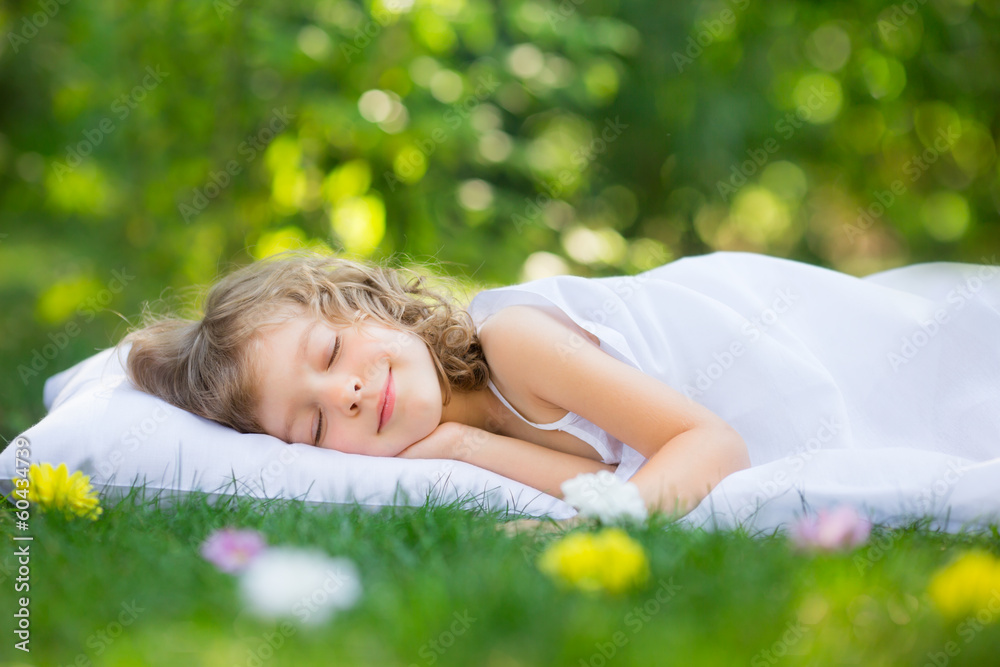 Wall mural kid sleeping in spring garden