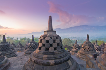 Sunrise Borobudur Temple Stupa in Yogyakarta, Java, Indonesia... - obrazy, fototapety, plakaty
