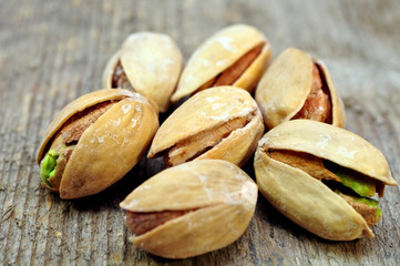 pistachios into a bowl on the table