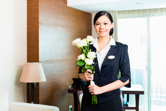 Asian Chinese hotel manager welcomes arriving VIP guests
