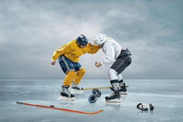 Fototapeta na wymiar Two ice hockey player boxing on the ice