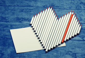 Fototapeta premium Pencils in a heart shape with place for text