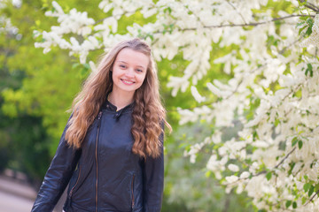 Beautiful young girl in a park on a spring day