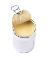 Condensed milk in tin cans over white background