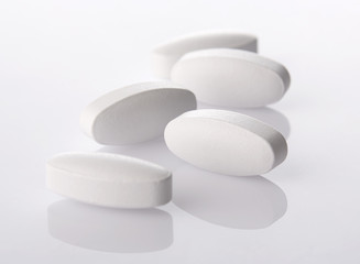 White pills on acrylic background