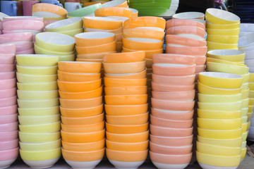 Stacks of colorful bowl in warehouse