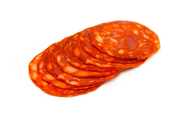 Sliced chorizo sausage isolated on a white studio background.