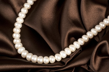Pearls a necklace on a silk fabric