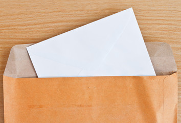 Blank envelope on wood background