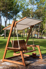 Fototapeta na wymiar Bench swing with canopy outdoors