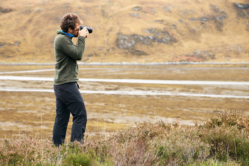 Nature photographer in the ourdoors, Highlands, Scotland, Europe