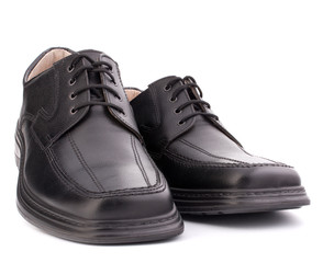 Black glossy man’s shoes with shoelaces