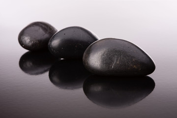 Fototapeta na wymiar Spa stone arrangement on black surface
