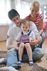 family at home using tablet computer