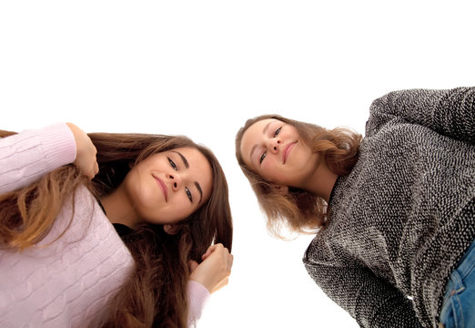two young girlfriends looking down